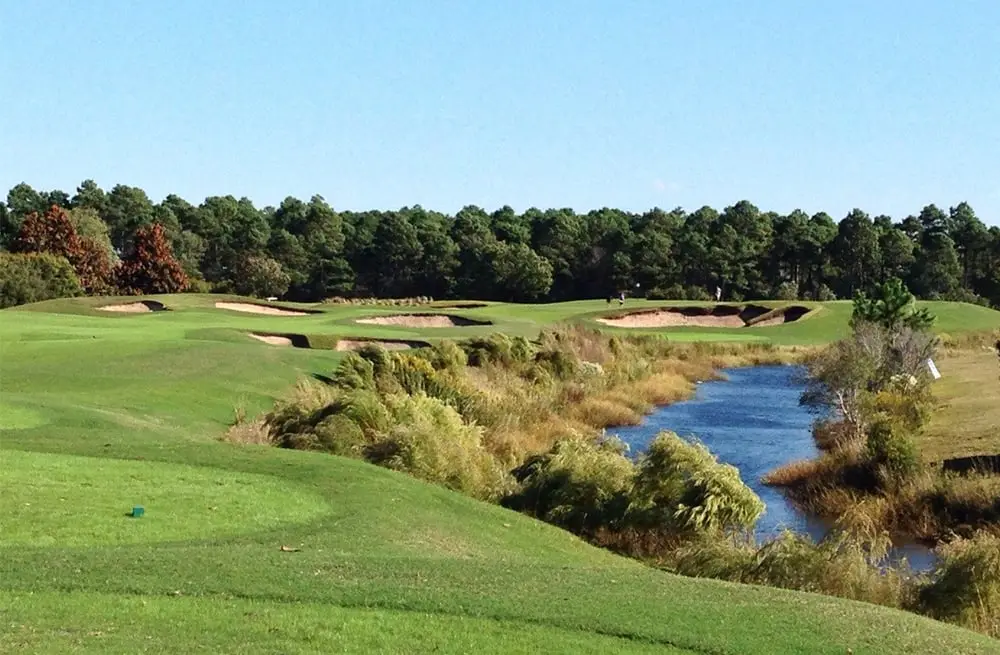 Tree lined fairway and deep bunkering on the Parkland course at Legends Resort