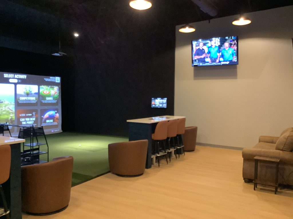 Simulator bay, high tops and lounge seating at Net Par Shallotte in Brunswick County