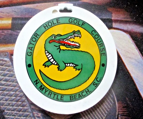 A round plastic Gator Hole Golf Course bag tag with a green alligator logo, North Myrtle Beach, S.C.