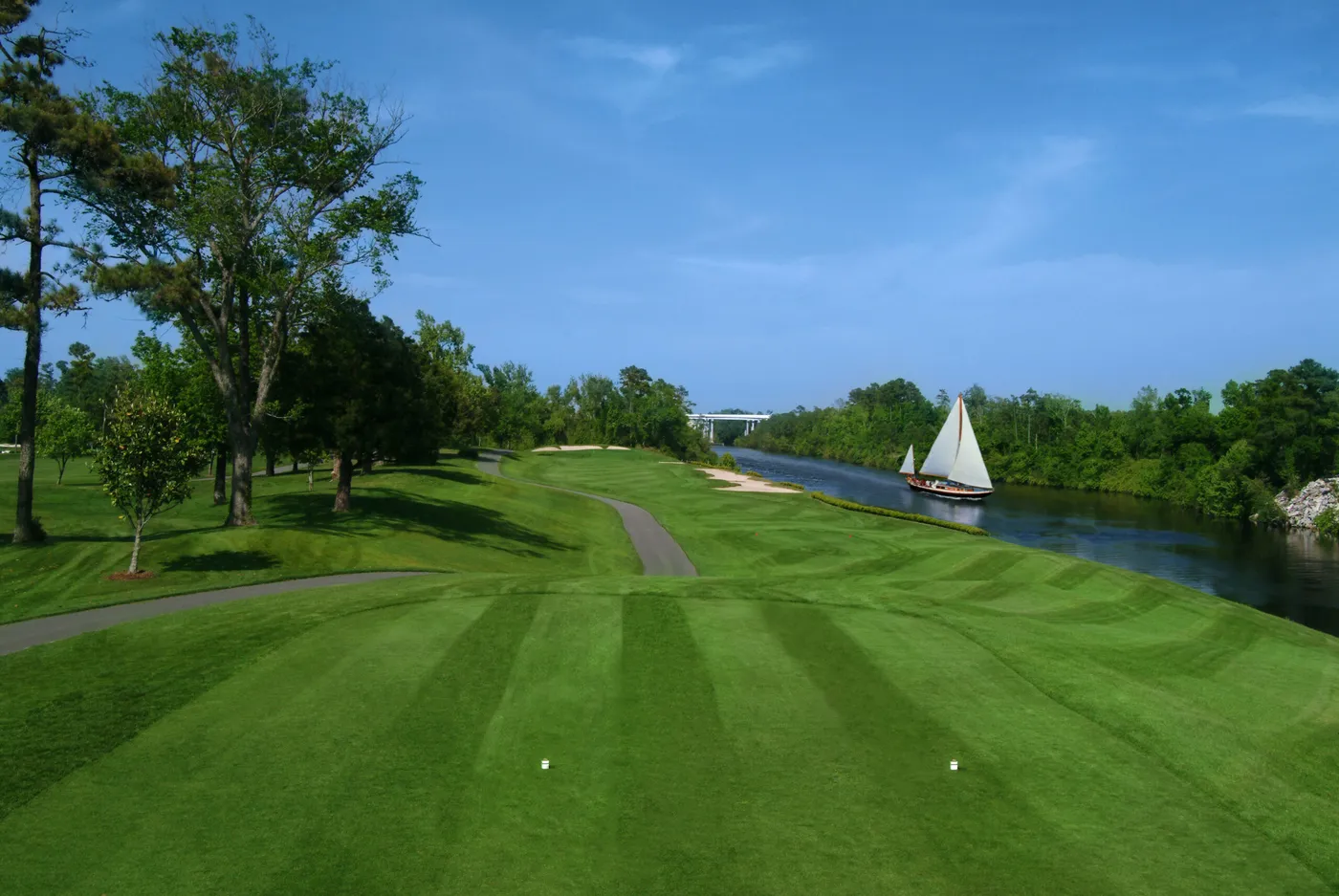 The Waterway Hills gondola cable car crossing high above the Intracoastal Waterway with golf holes below