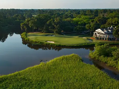 Hammock Coast Golf Trail package aerial of Caledonia with a creek beside the fairway