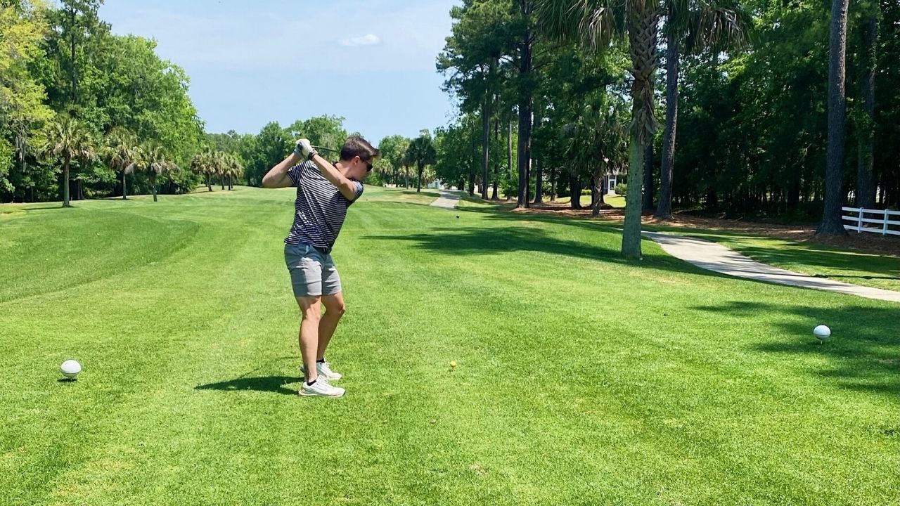 Golfer teeing off during a Myrtle Beach group golf trip